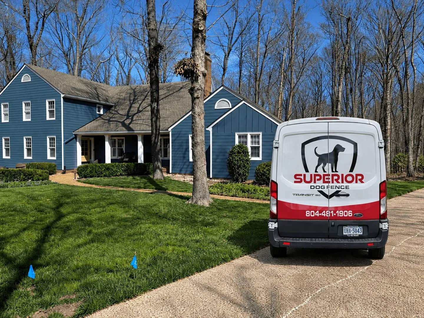 Boundary flags on a lawn with the Superior van in the driveway.